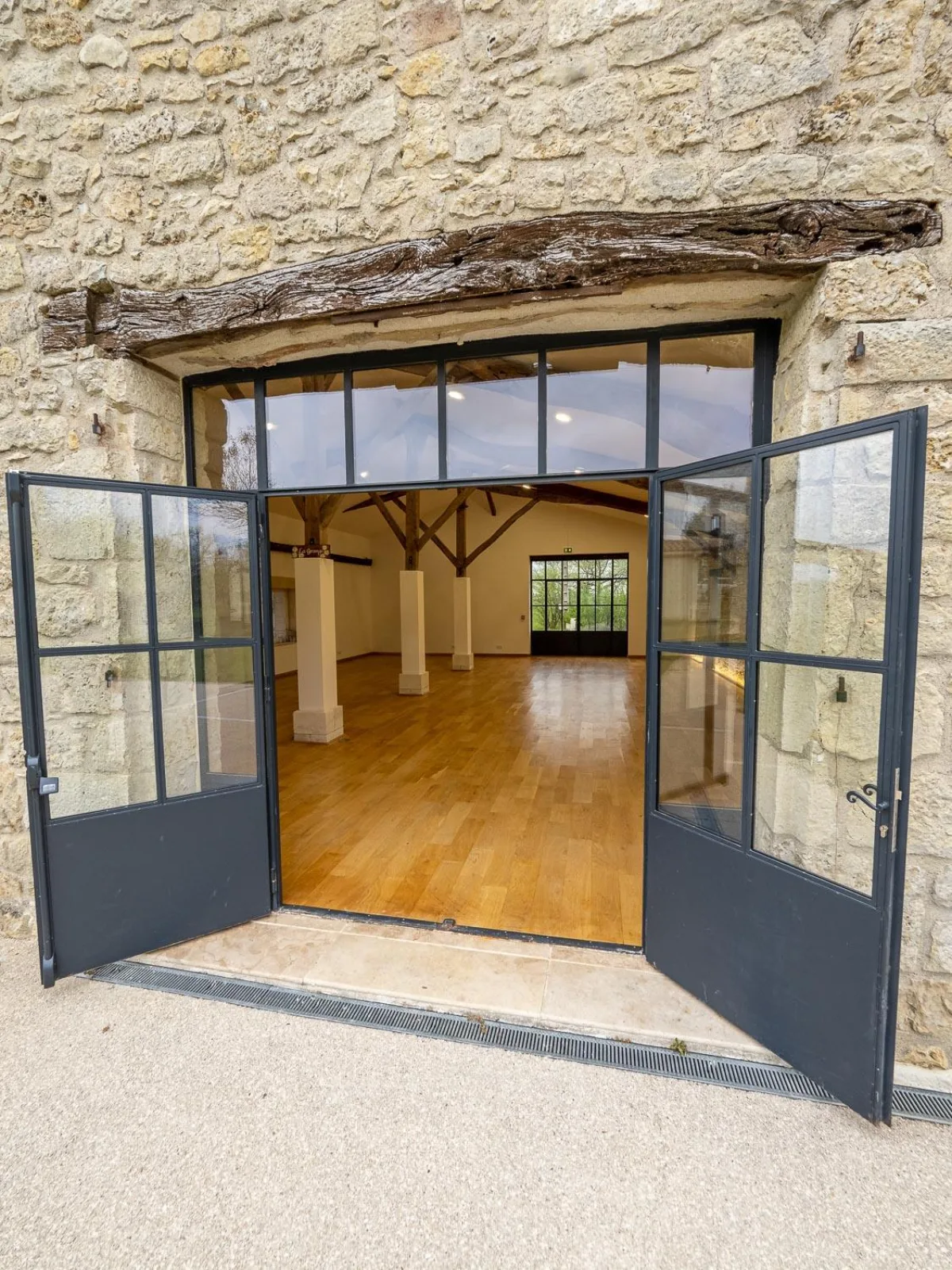 The steel-framed doors of the yoga shala open onto an empty oak floor, ready for the first session
